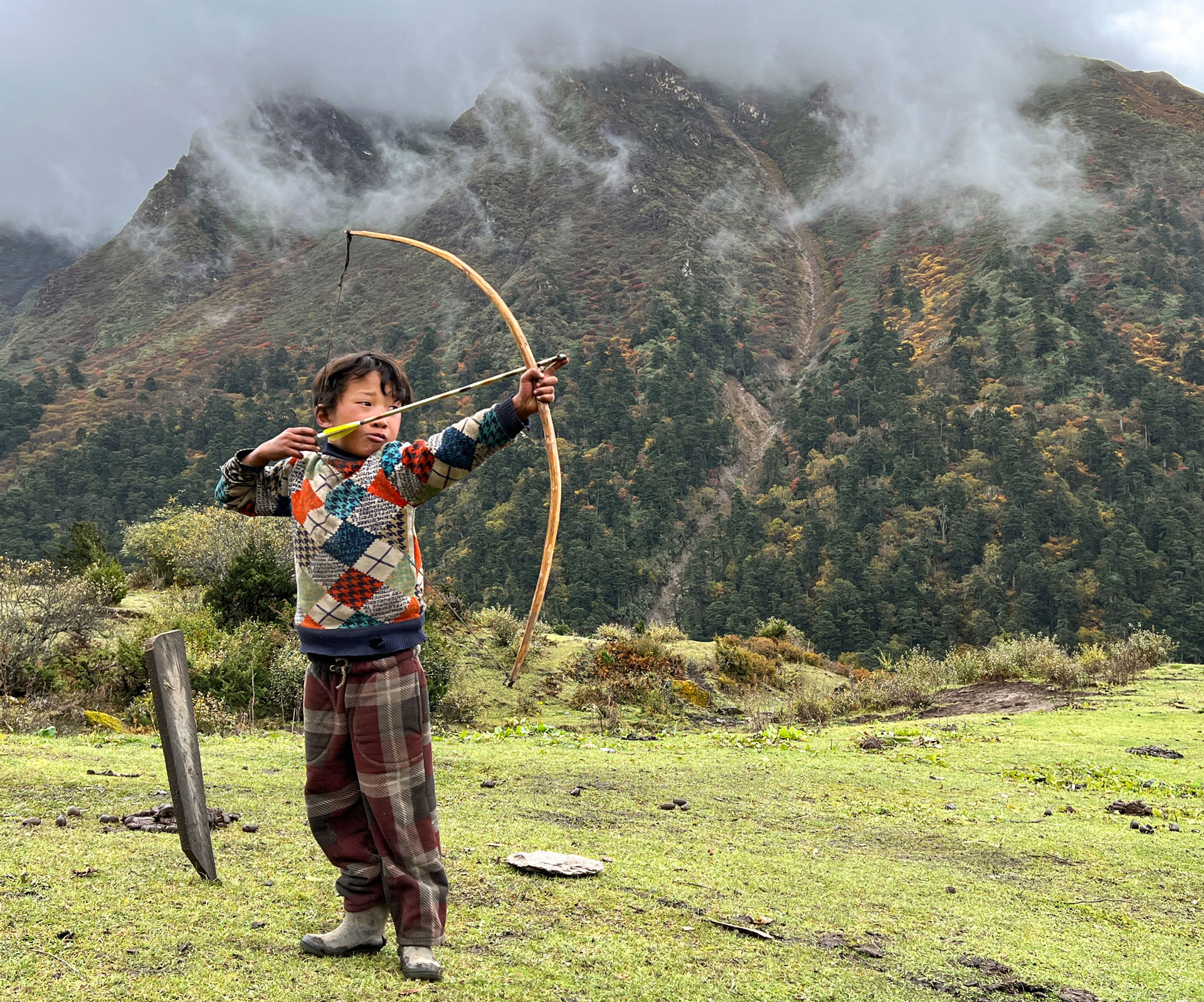 Child shooting a bow and arrow.