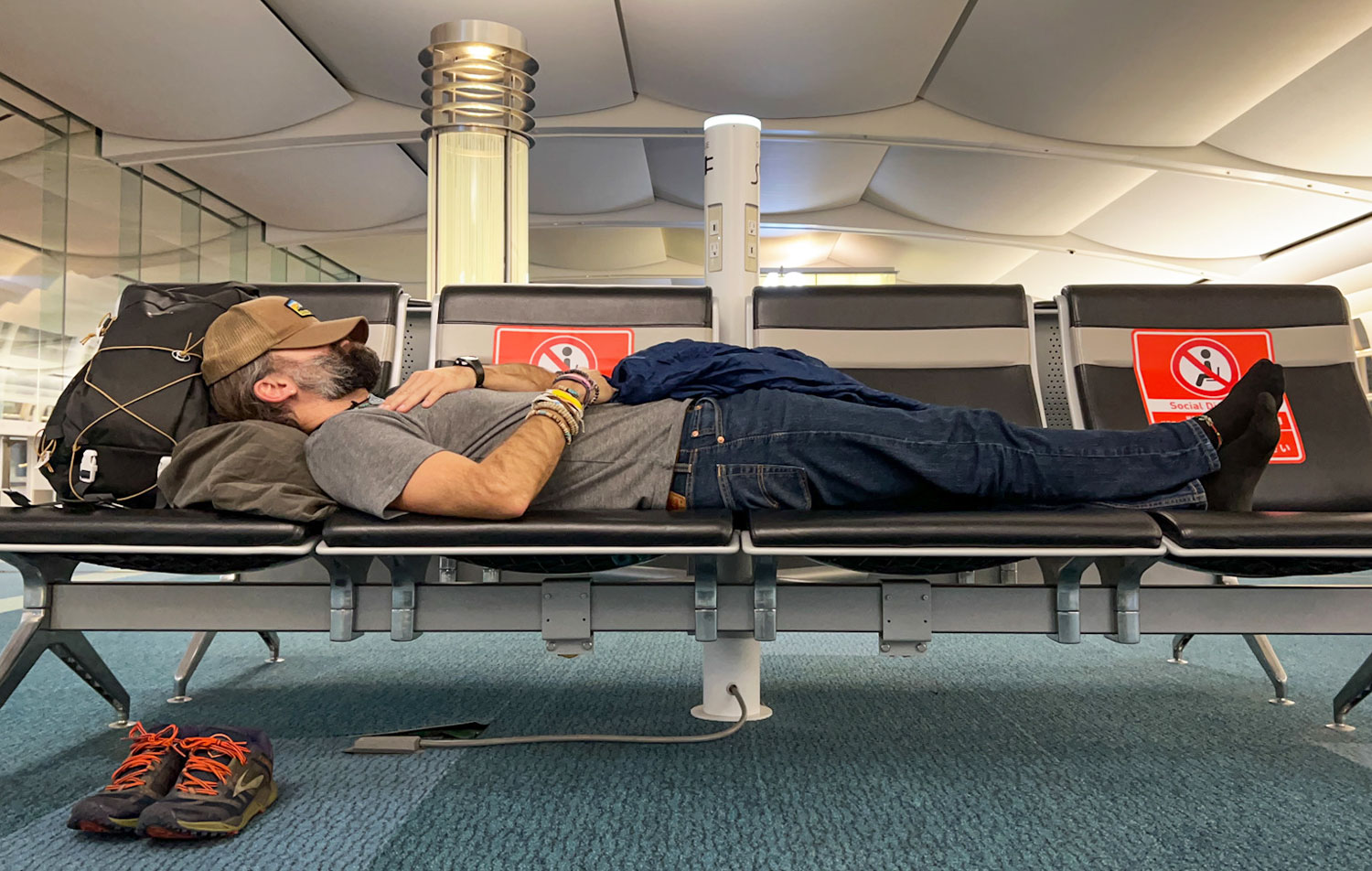 Chris sleeping in an airport.